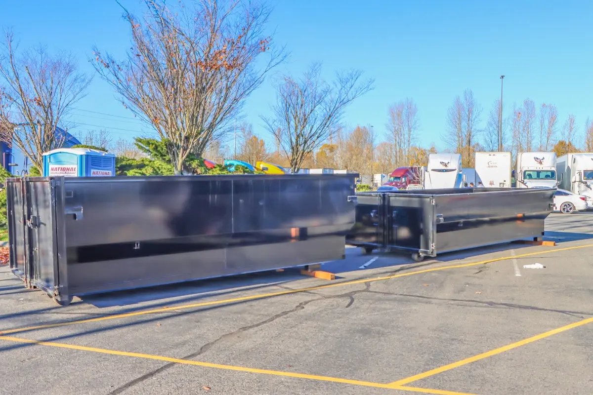 Professional dumpster rental service with roll-off container on residential driveway in Pevely